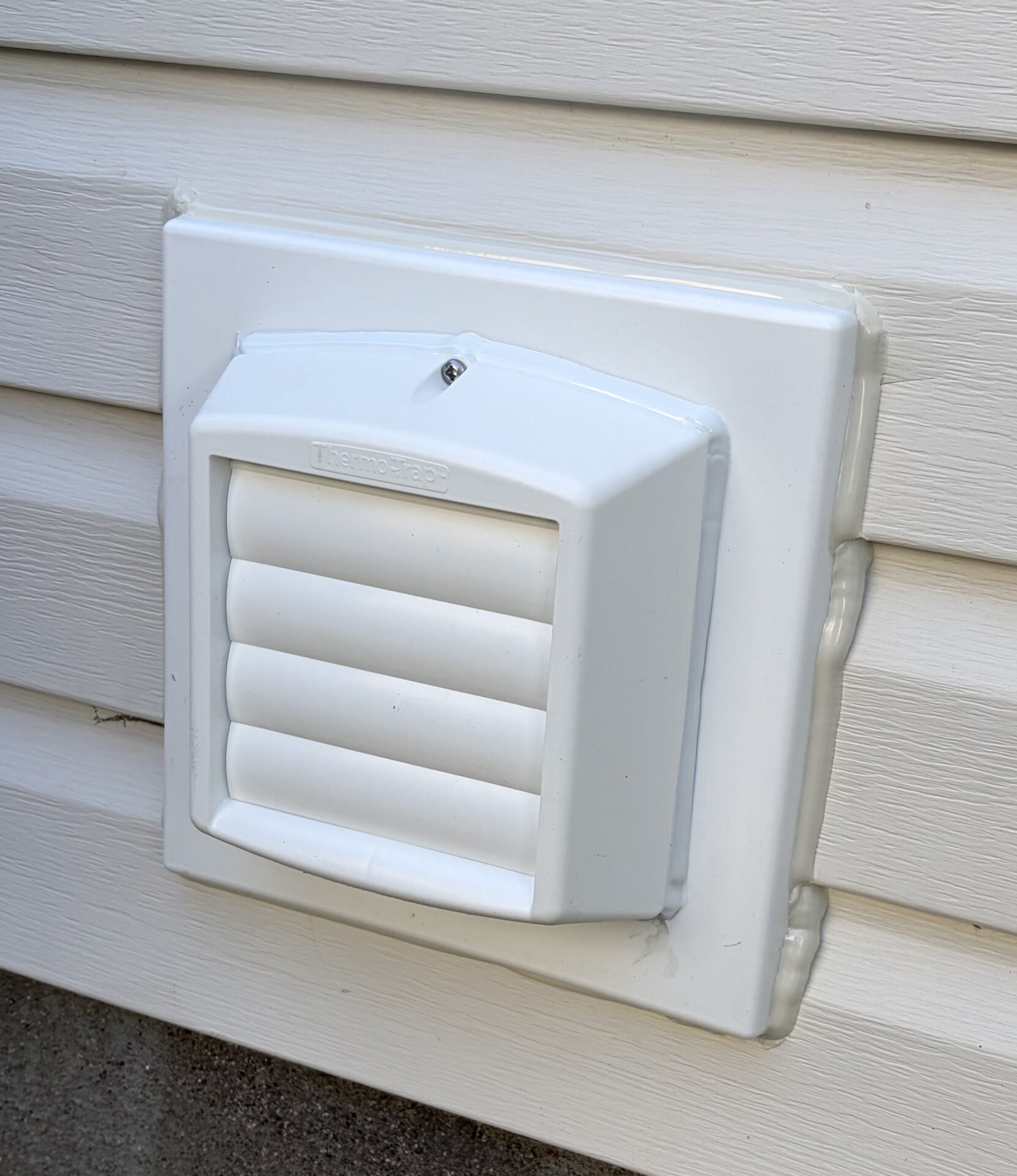 Thermo-Trap double-walled thermal ventilation trap installed on siding