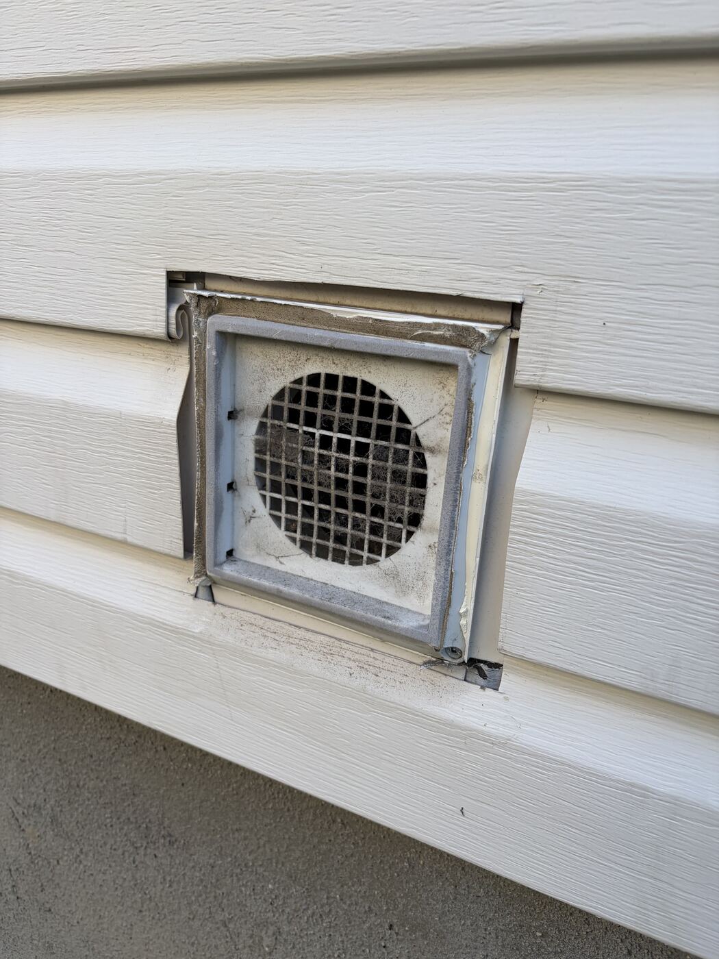 Old clogged wall exhaust vent before replacement