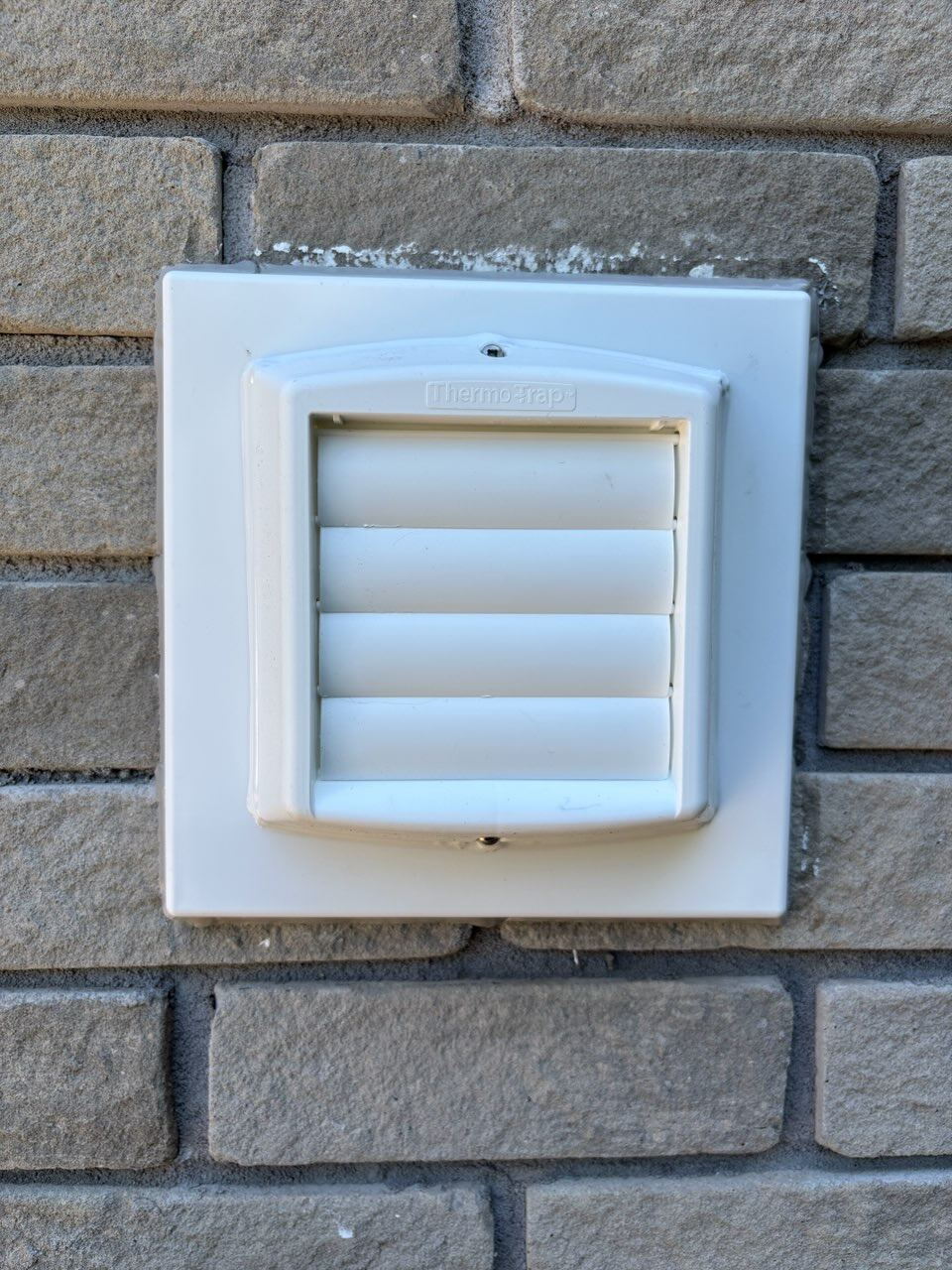 Finished Thermo-Trap vent installed on the brick wall