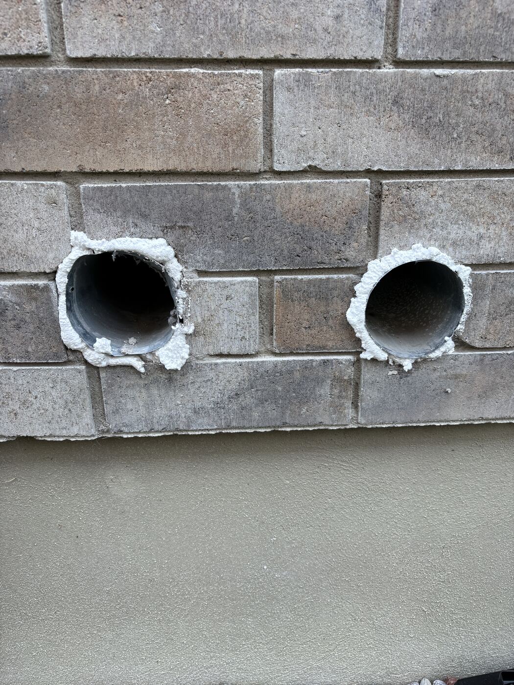 Both duct openings foam-sealed around the perimeter