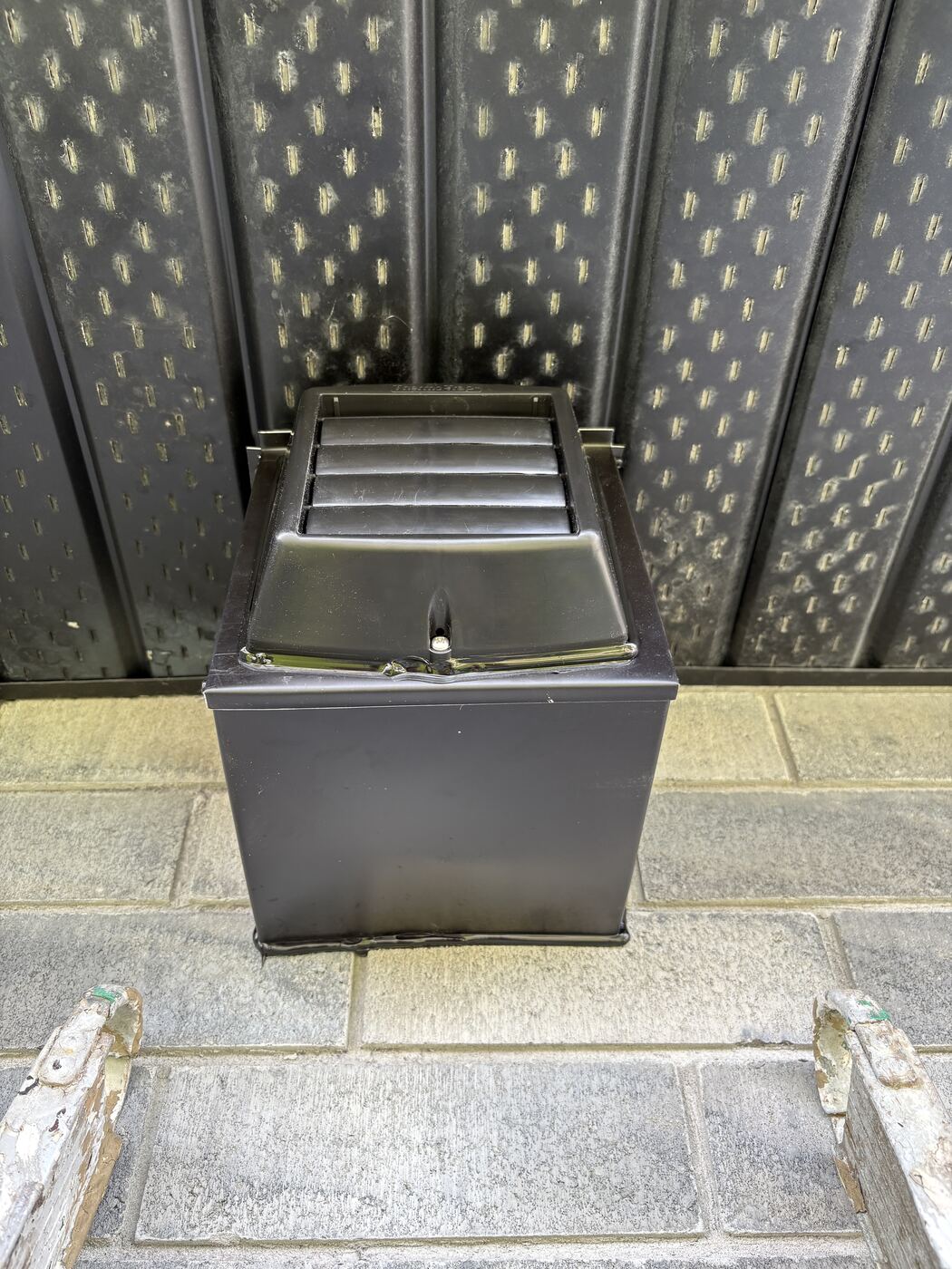 Black colour-matched insulated soffit box installed flush on the dark soffit