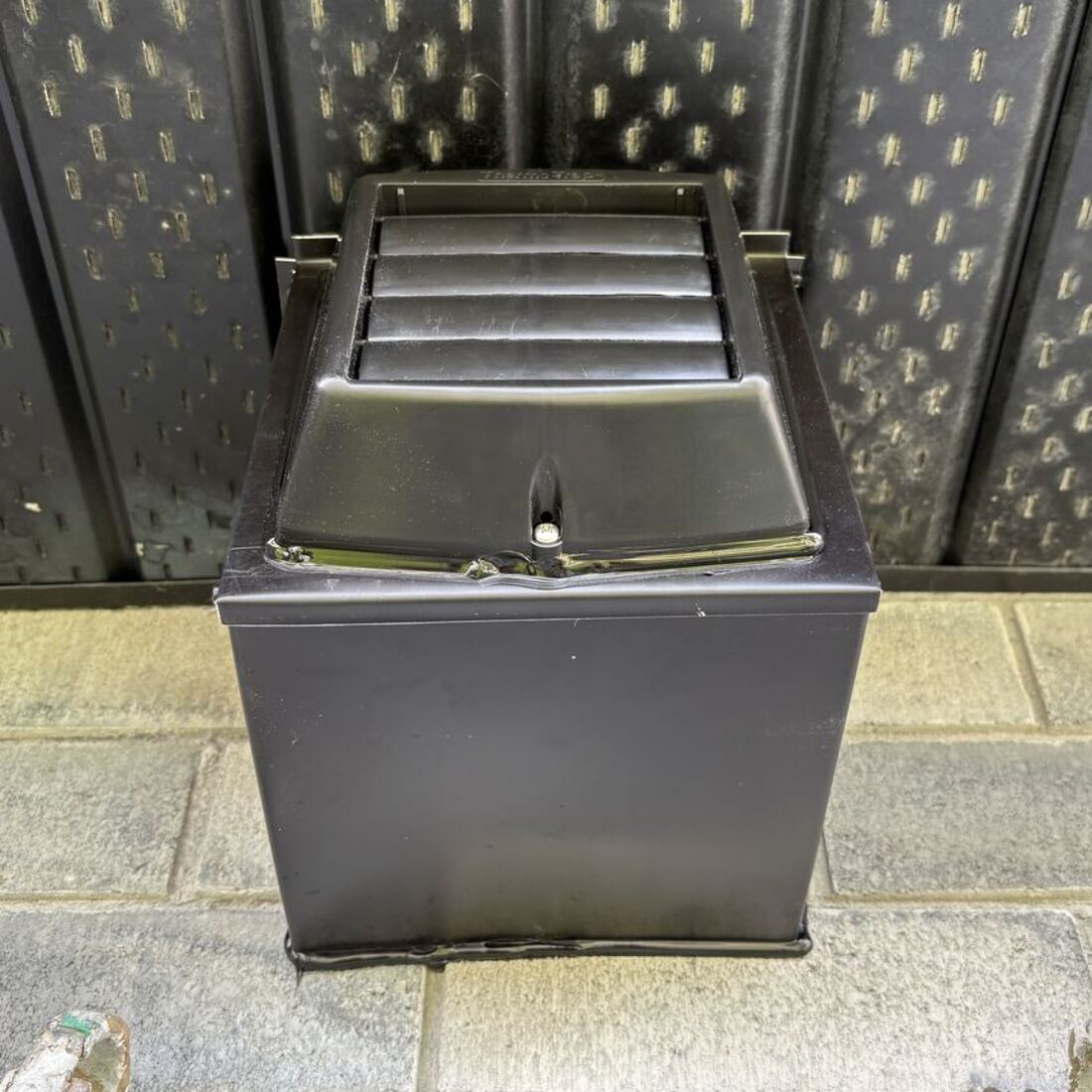 Black colour-matched insulated soffit box installed flush on a dark soffit