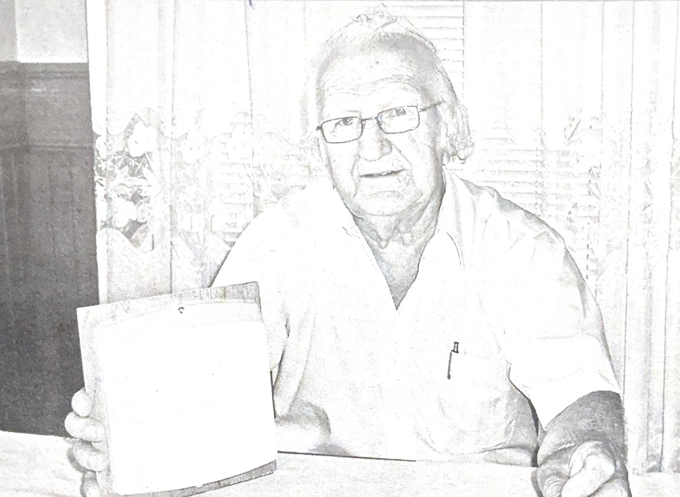 Inventor Normand Blanchard holding the Thermo-Trap he designed, featured in L'Acadie Nouvelle, 2010