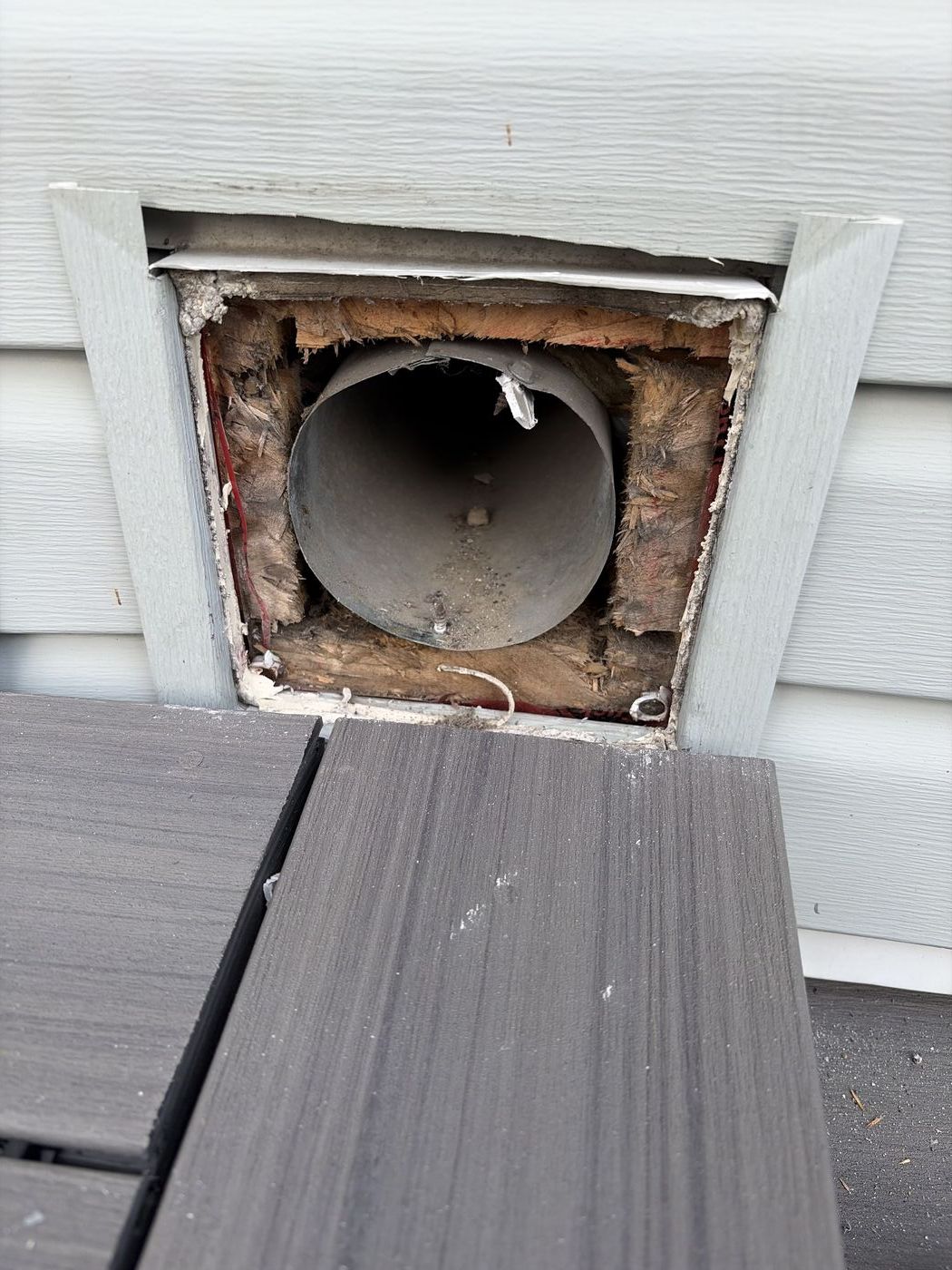 Open intake vent with the cover removed showing the exposed duct