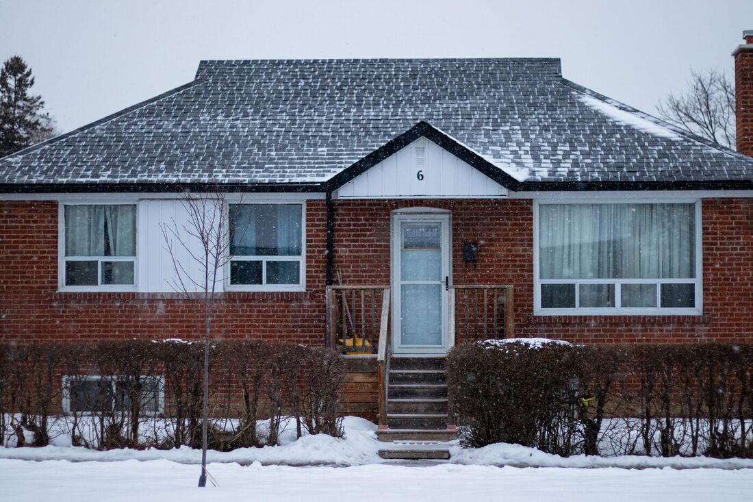 Snow-covered Canadian house in deep winter, the conditions that ice metal vent flaps shut